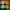 Four colorful Orinoco massage candles in yellow, orange, blue, and green on a stone surface.