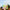 A pack of colorful pastel gradient taper candles held against a blue sky background.