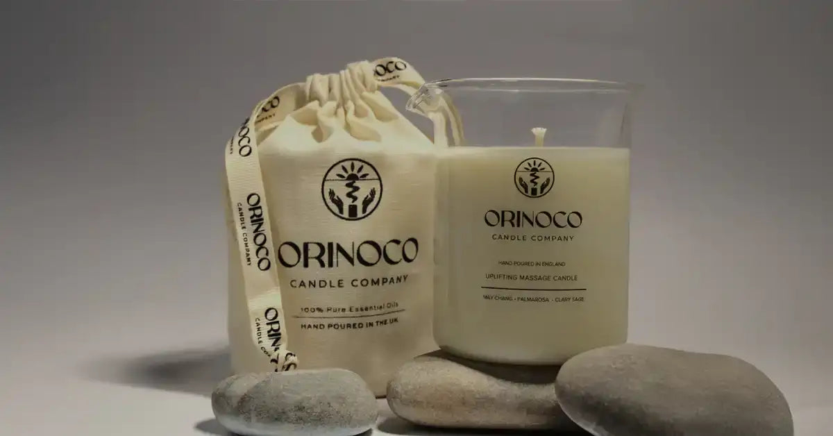 Orinoco Candle Company uplifting massage candle in a glass jar with a fabric drawstring pouch.