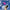 Hand holding a bundle of pink and blue gradient tapered candles against a blue cloudy sky