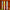 Three pastel gradient taper candles in blue, yellow, and pink against a wooden background.