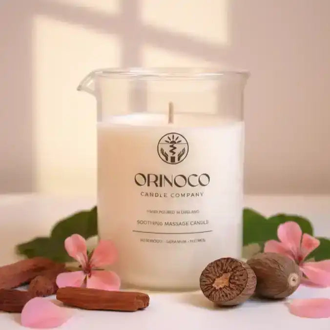 Orinoco Candle Company soothing massage candle in a glass jar with botanicals and nuts.