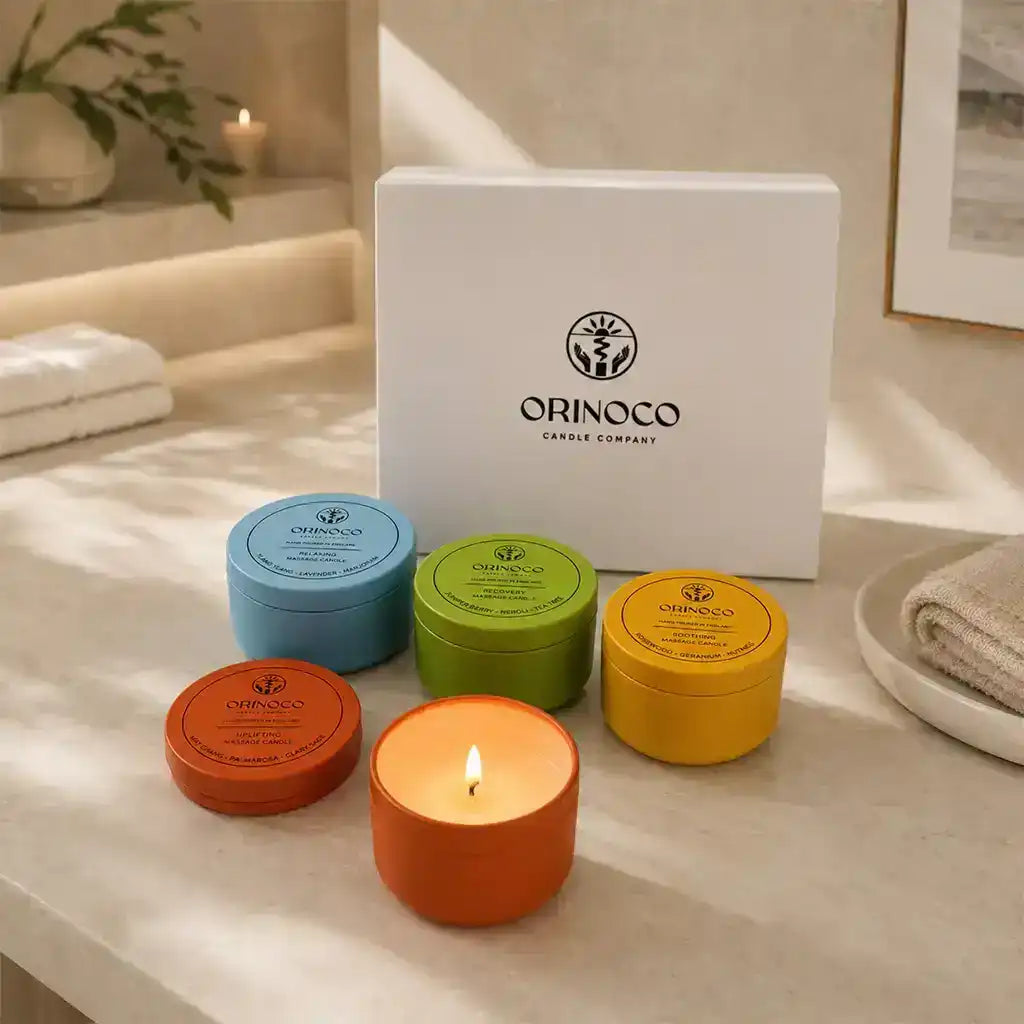 Collection of colorful Orinoco Candle Company scented candles and gift box on a counter.