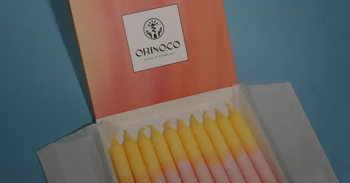 Orinoco Candle Company gift box with yellow and pink gradient taper candles.
