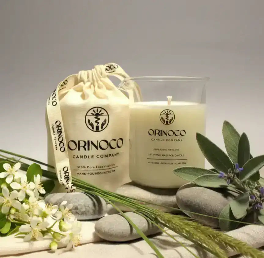 Orinoco Skincare candle and matching gift bag with natural stones and greenery.