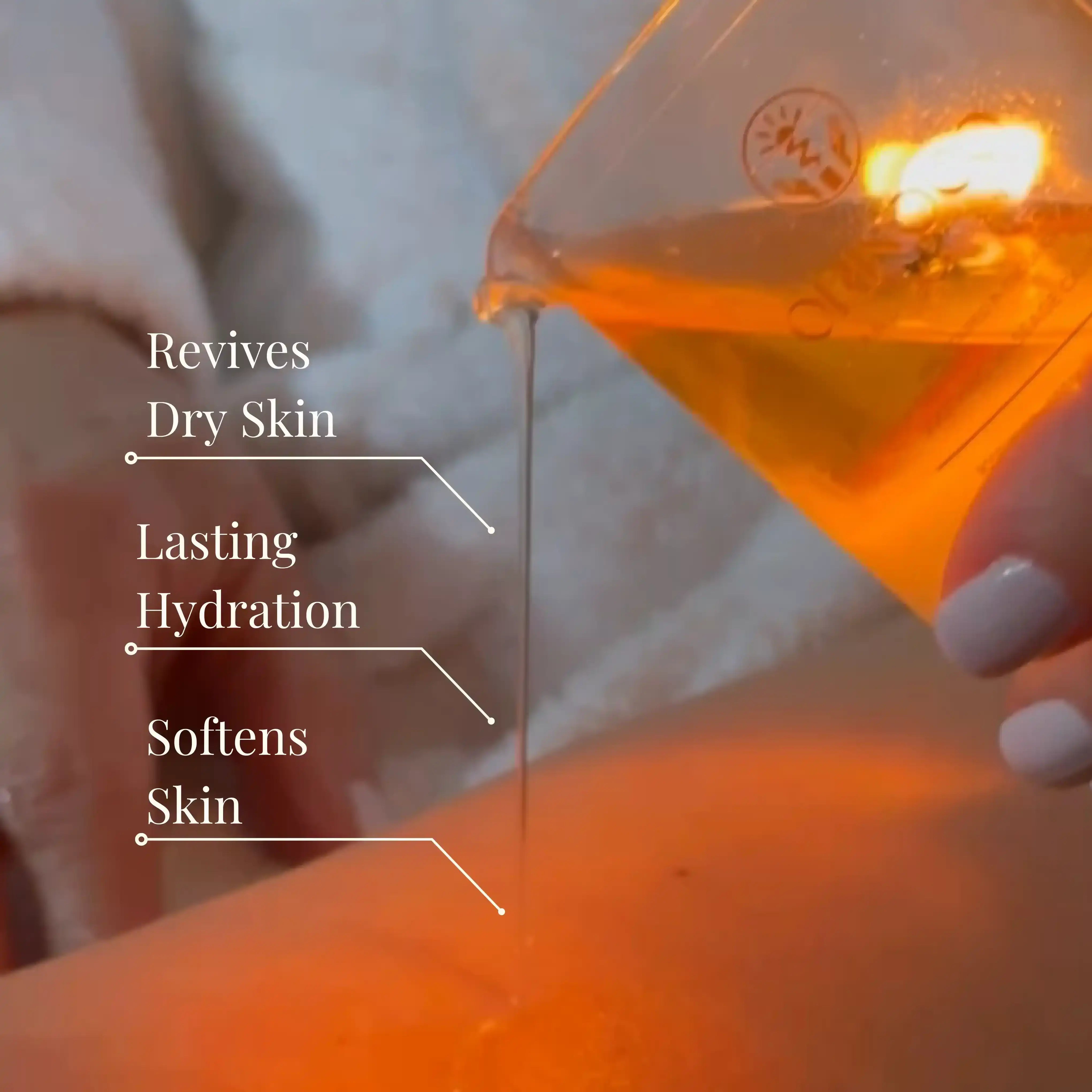 Golden body oil being poured onto skin for hydration and softening.