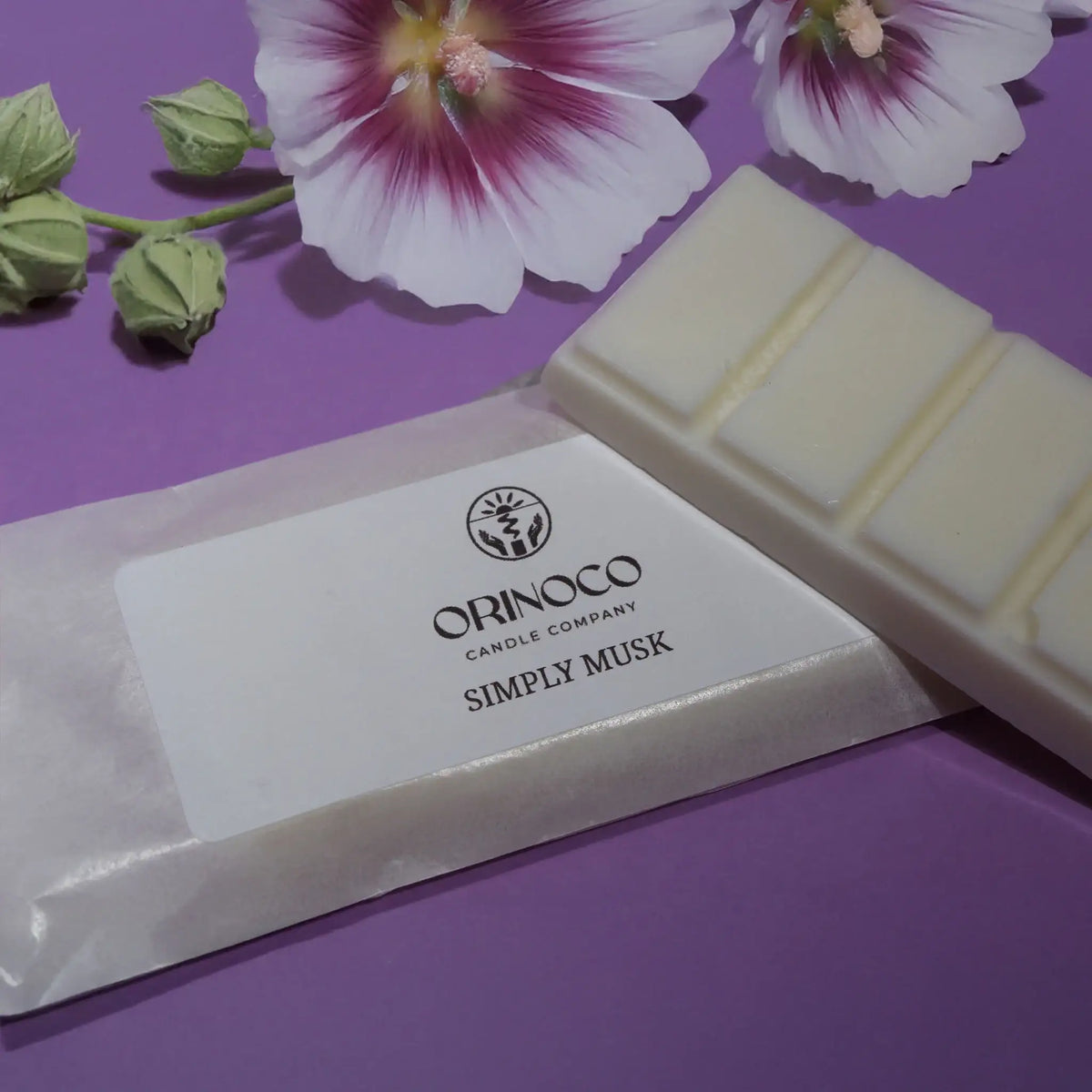 Orinoco Candle Company Simply Musk wax melt bar with white flowers on a purple background