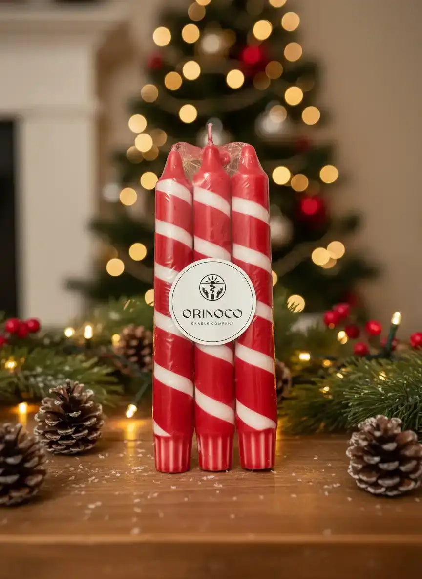 Orinoco Candle Company red and white striped candy cane candles on a festive holiday table.